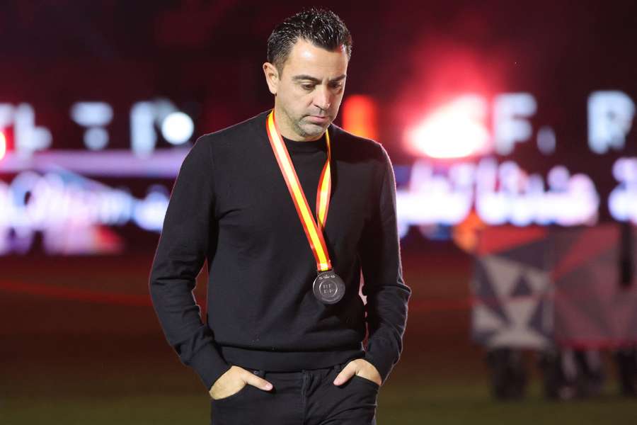 Barcelona's Spanish coach Xavi walks during the medal ceremony