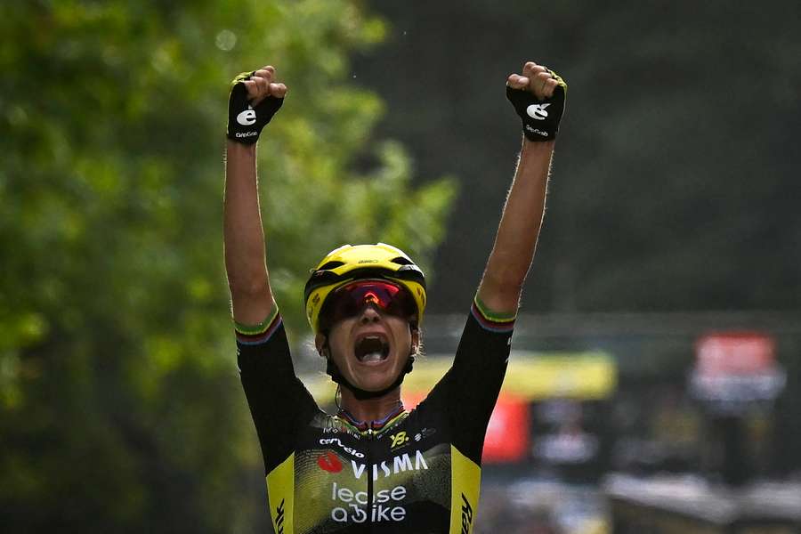 Marianne Vos celebrates as she crosses the finish line to win the first stage of the Tour de France Femmes