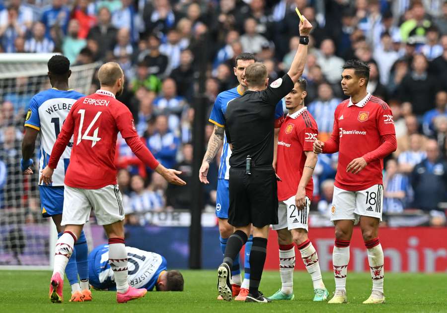 Casemiro is shown a yellow card by the referee Casemiro is shown a yellow card by the referee