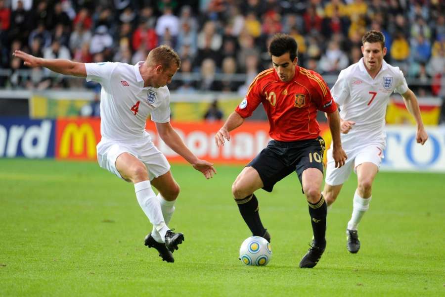 Cattermole (L) and James Milner (R) look to win the ball