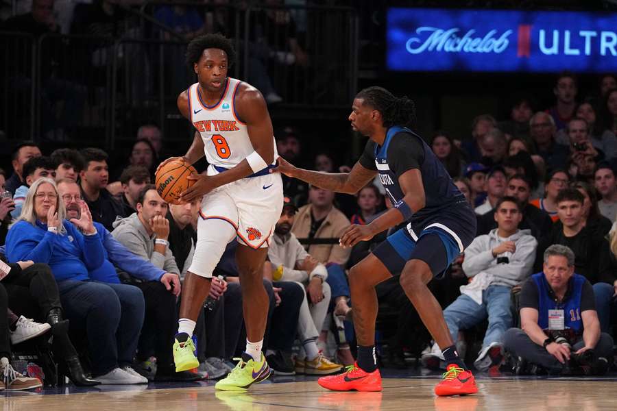 OG Anunoby of the New York Knicks controls the ball against Naz Reid of the Minnesota Timberwolves