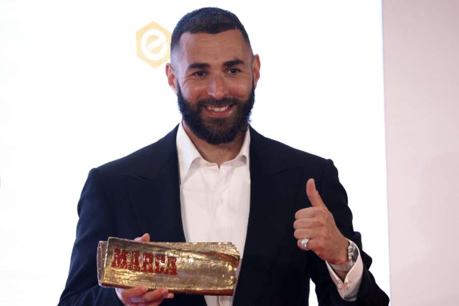 Real Madrid's Karim Benzema poses with the Marca Legend award