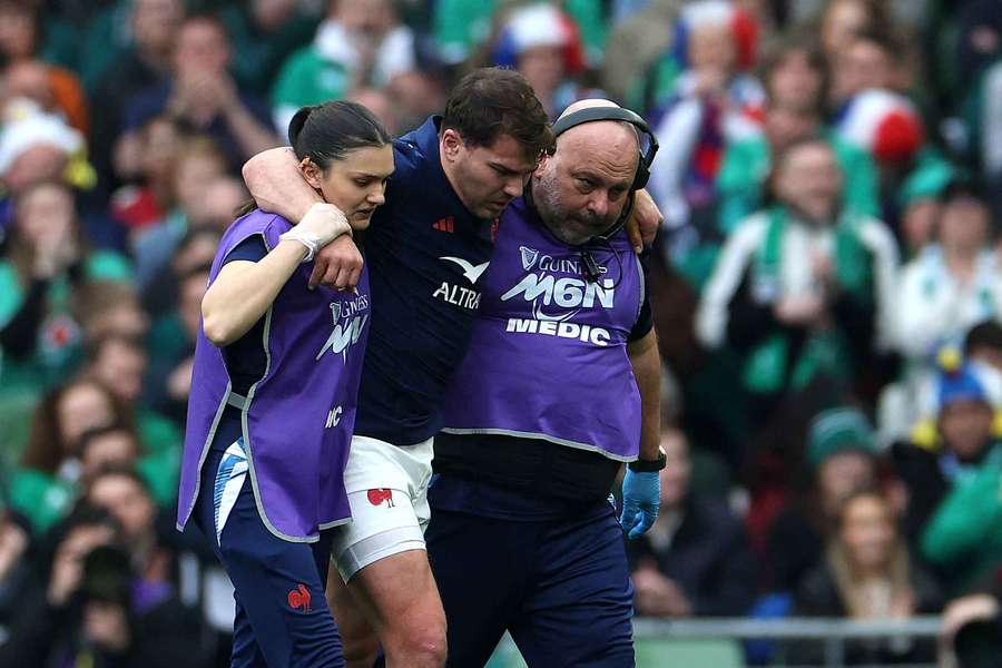 Antoine Dupont walks off the field after injuring his knee against Ireland