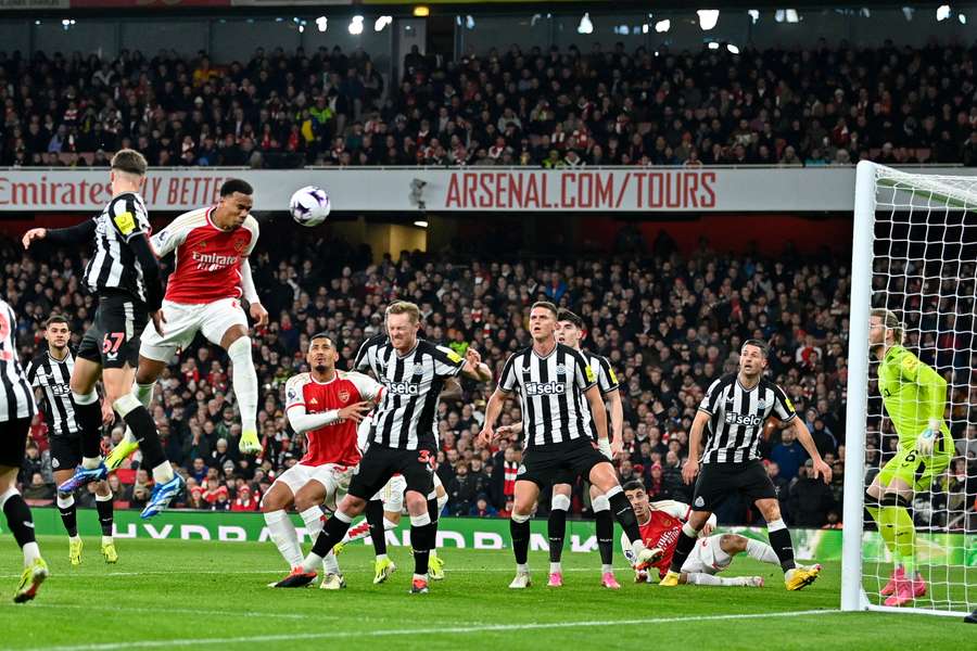 Loris Karius (R) saves this header from Arsenal's Brazilian defender #06 Gabriel Magalhaes (3L) in the build-up to an own-goal