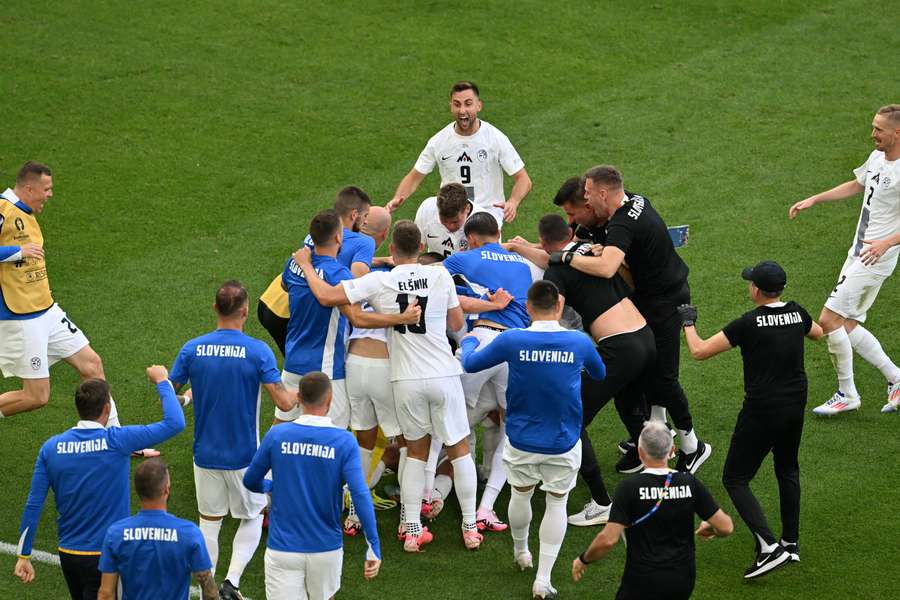 Slovenia's full squad celebrate their deflected leveller