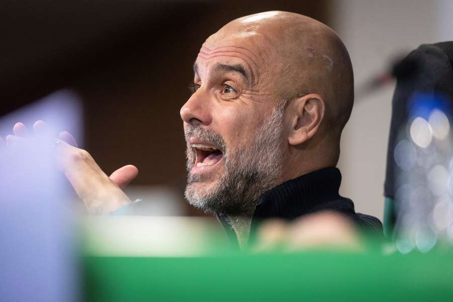 Pep Guardiola reacts during a press conference ahead of Man City's match against Sporting Lisbon