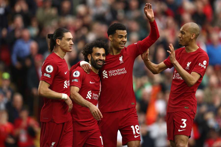 Liverpool's Egyptian striker Mohamed Salah (2L) celebrates with teammates after scoring his team's first goal