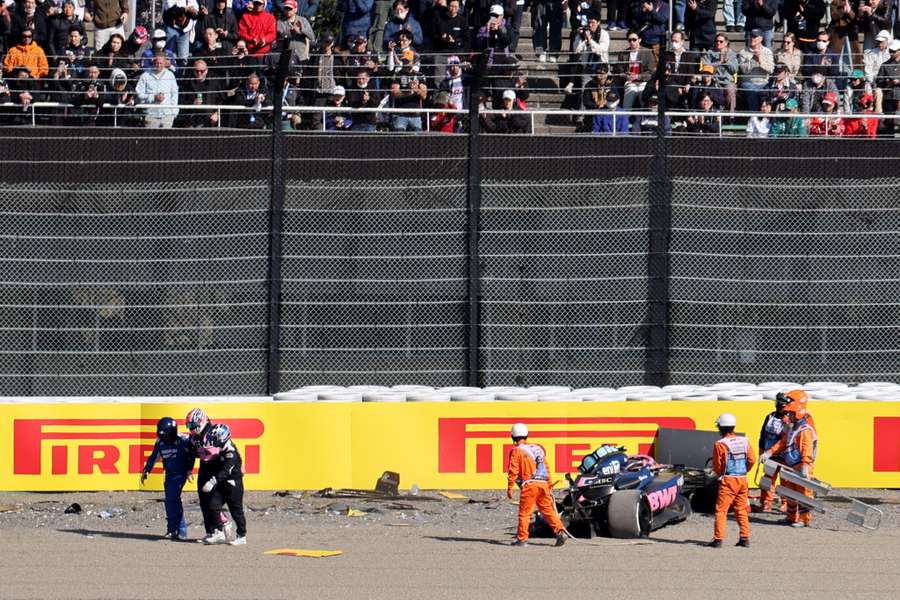 Alpine's Jack Doohan walks away with a medical team as marshals attend his car after the crash