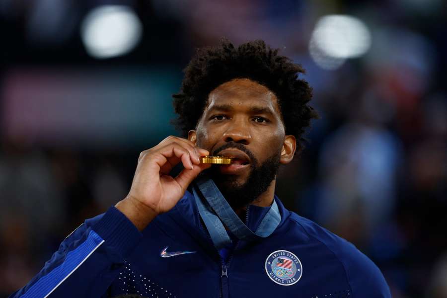 Joel Embiid of the United States bites his Olympic gold medal