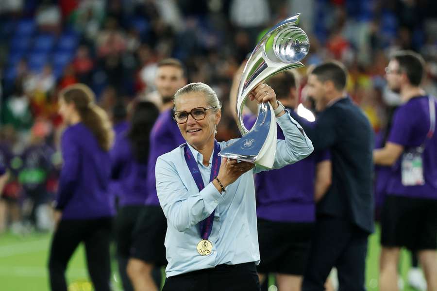 Sarina Wiegman celebrates with the UEFA Women's EURO trophy after England's penalty shootout win over Spain