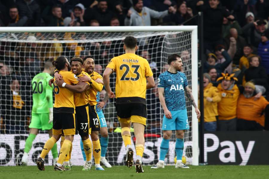 Wolverhampton Wanderers' Spanish midfielder Adama Traore (C) celebrates with teammates