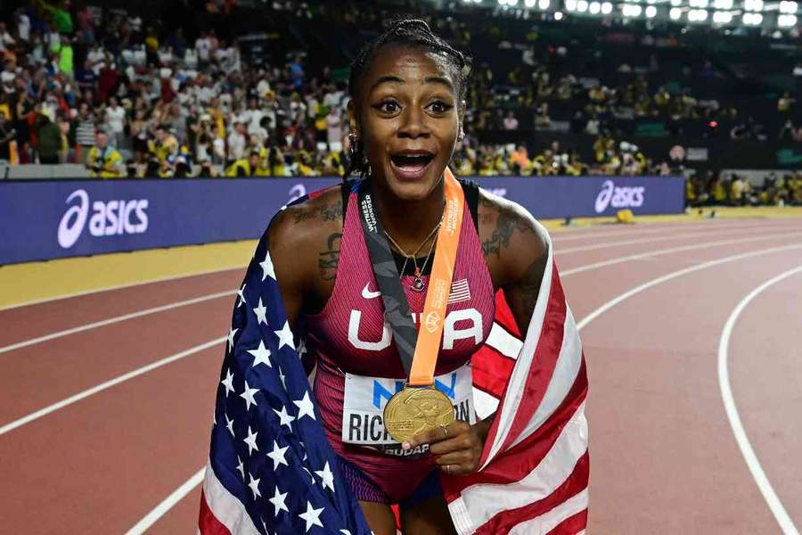 Sha'Carri Richardson celebrates with her gold medal after winning the 100m