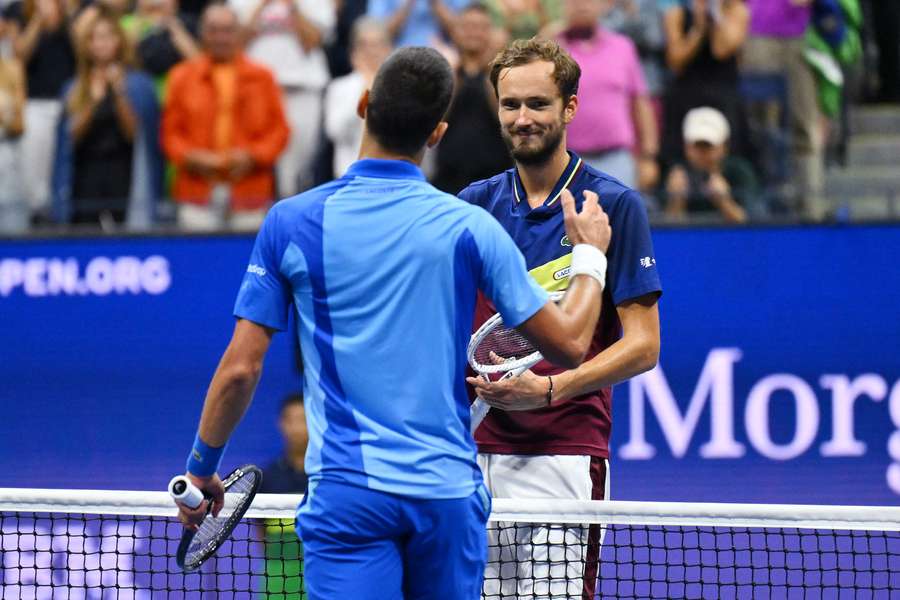 Medvedev (R) shakes hands with Djokovic following their match