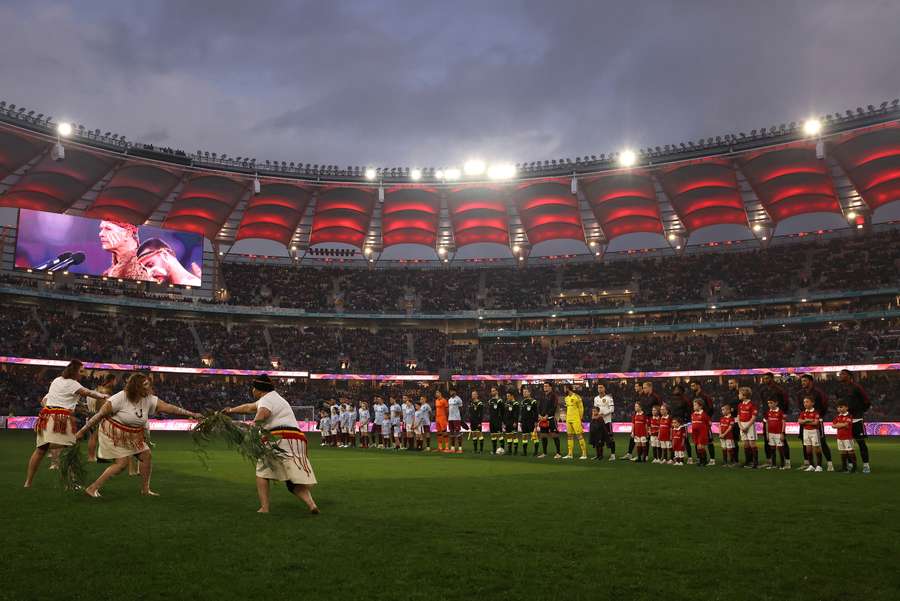 Aston Villa and Manchester United players observe a cultural ceremony before a friendly in Perth. 