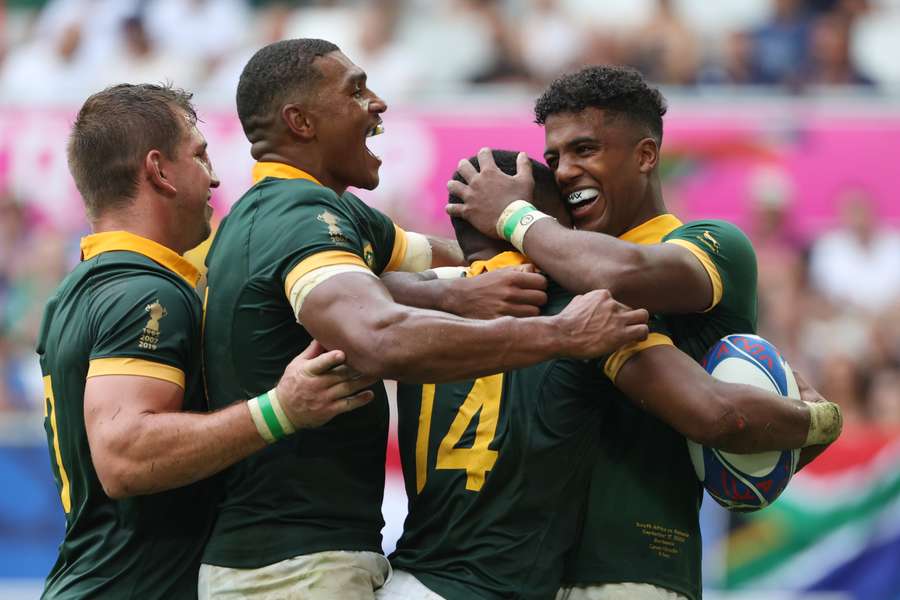 South Africa scrum-half Grant Williams (2R) celebrates with teammates