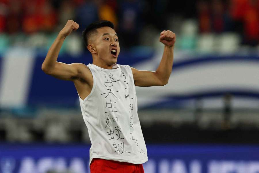 The pitch invader is seen after running onto the pitch during the match between China and Japan