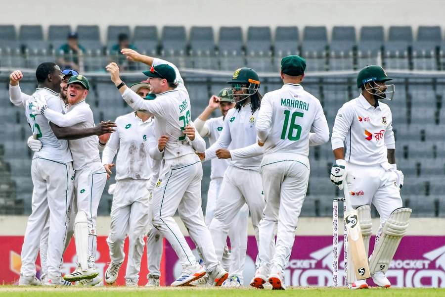 Kagiso Rabada (left) celebrates with teammates after taking the wicket of Bangladesh's Liton Das during first Test between Bangladesh and South Africa