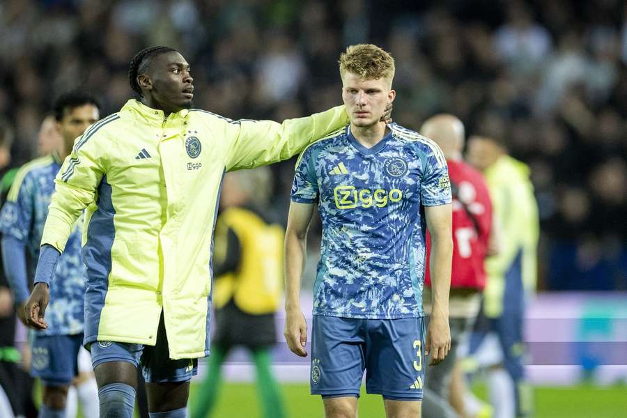 Anton Gaaei is consoled by team-mate Jorthy Mokio after Ajax loses the Dutch championships at the last matchday in Groningen.