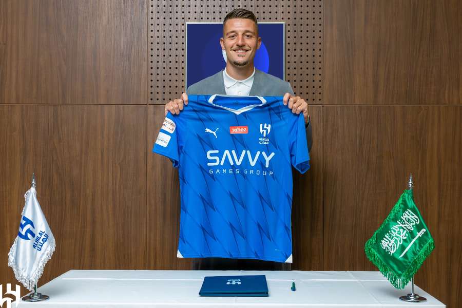 Milinkovic-Savic holding the Al-Hilal shirt