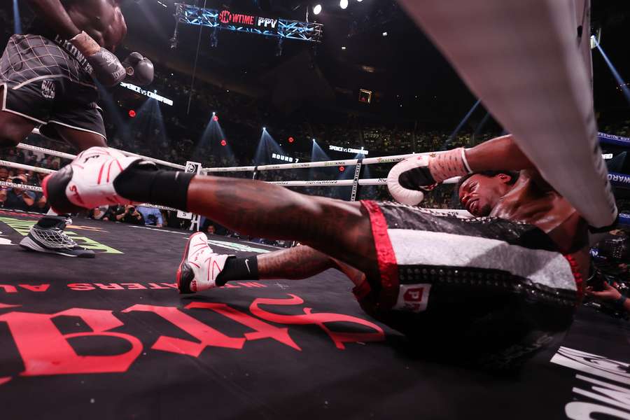 Errol Spence Jr. is knocked to the mat by Terrence Crawford during round 7