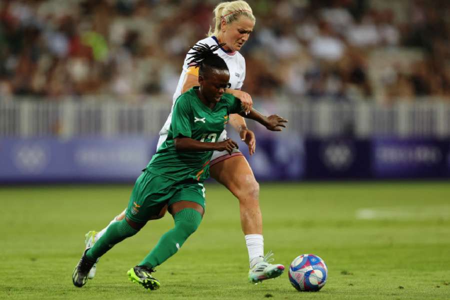 Avell Chitundu of Zambia battling for the ball with USA's Lindsey Horan 