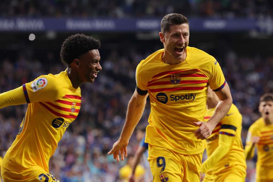 Barcelona forward Robert Lewandowski (R) celebrates