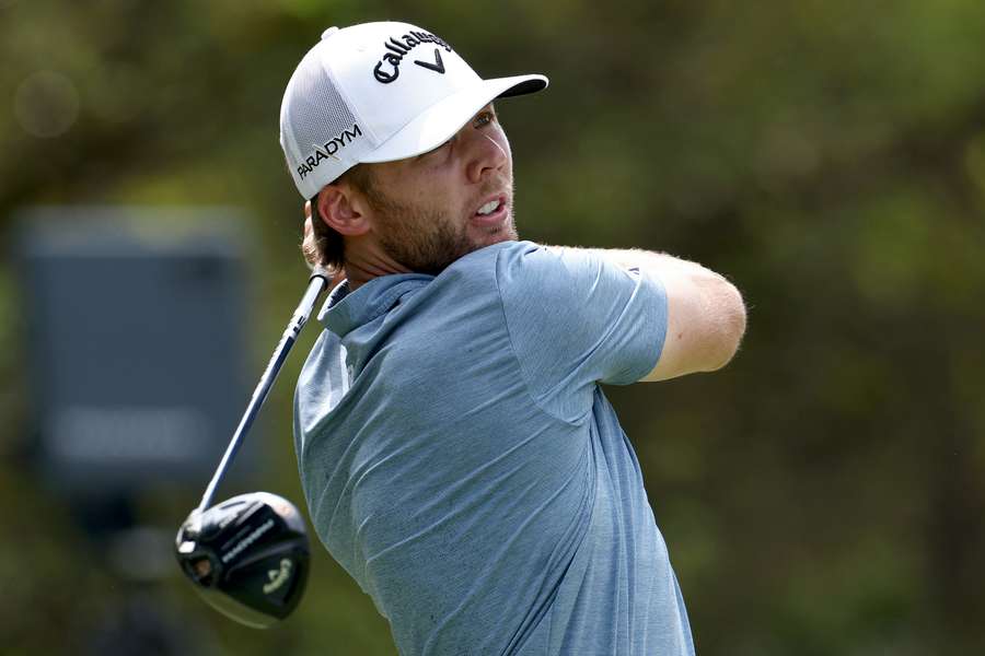 Sam Burns of the United States plays his shot from the 18th tee 