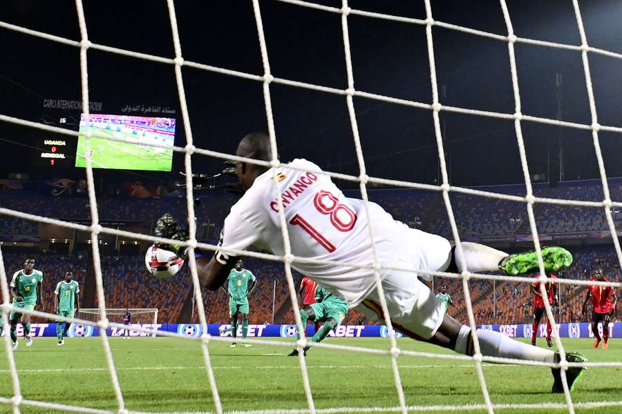 Denis Onyango leaps to save a penalty during the 2019 Africa Cup of Nations match between Uganda and Senegal 