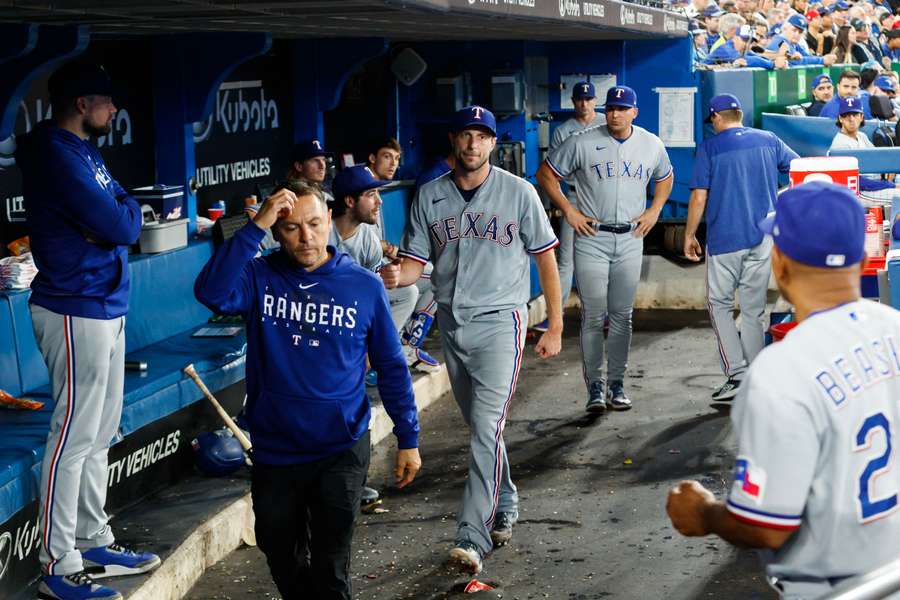 Max Scherzer of the Texas Rangers walks through the dugout after leaving the game in the sixth inning against the Toronto Blue Jays