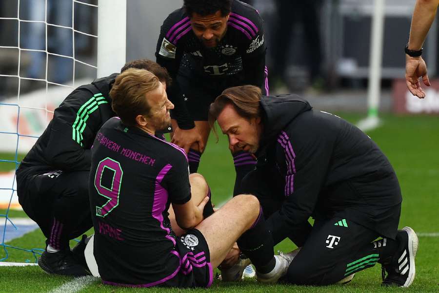 Bayern Munich's Harry Kane receives medical attention after sustaining the injury