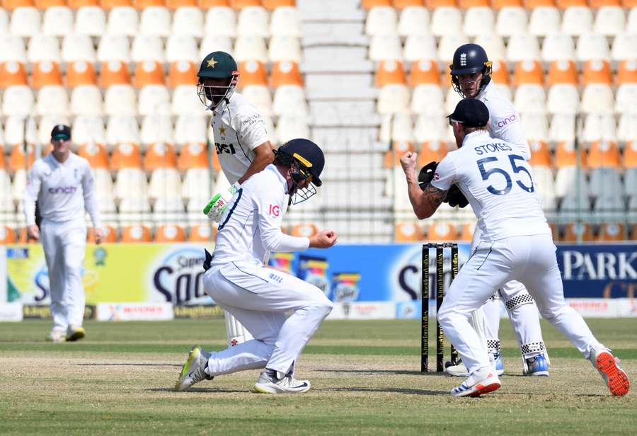 England's Ollie Pope celebrates after taking the catch to dismiss Pakistan's Shan Masood, off the bowling of Shoaib Bashir