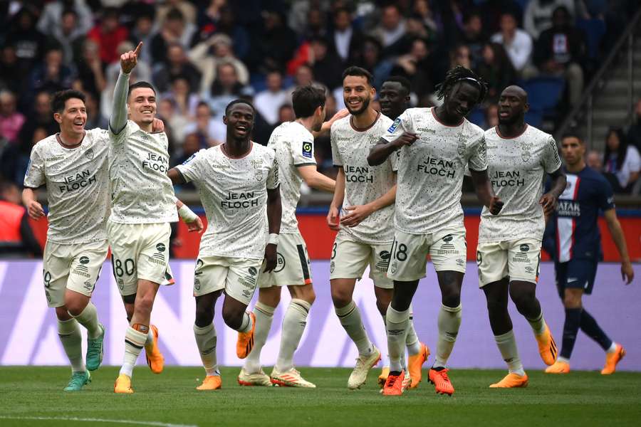 Lorient players celebrate the opening goal