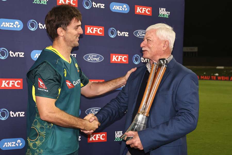 Mitchell Marsh is presented the Chappell–Hadlee Trophy by former New Zealand cricketer Richard Hadlee