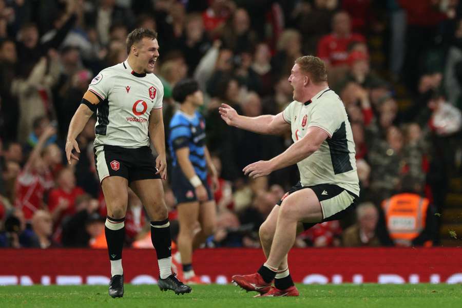 Wales' Jarrod Evans (L) celebrates after kicking a last-minute penalty to win the Autumn Nations Series match against Japan Wales' Jarrod Evans (L) celebrates after kicking a last-minute penalty to win the Autumn Nations Series match against Japan