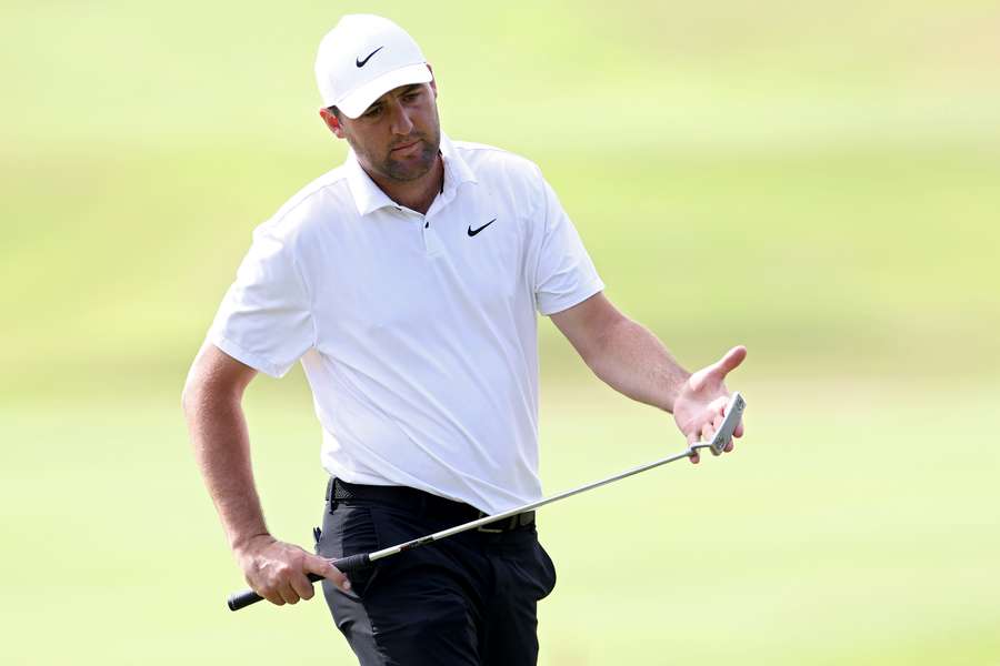 Scottie Scheffler of the United States lines up a putt on the 12th green