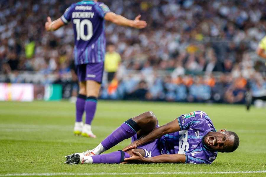 Collins Sichenje of Charlton Athletic cries out in pain as he holds his injured knee Collins Sichenje of Charlton Athletic cries out in pain as he holds his injured knee