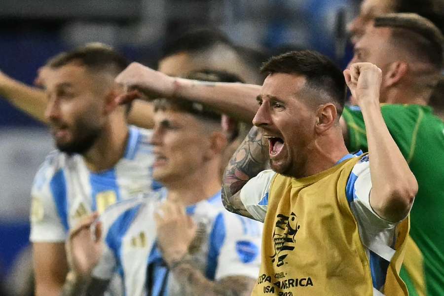 Messi celebrates win with his teammates on the bench