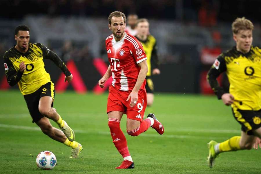 Bayern Munich's Harry Kane drives the ball forwarded guarded by Felix Nmecha of Borussia Dortmund Bayern Munich's Harry Kane drives the ball forwarded guarded by Felix Nmecha of Borussia Dortmund