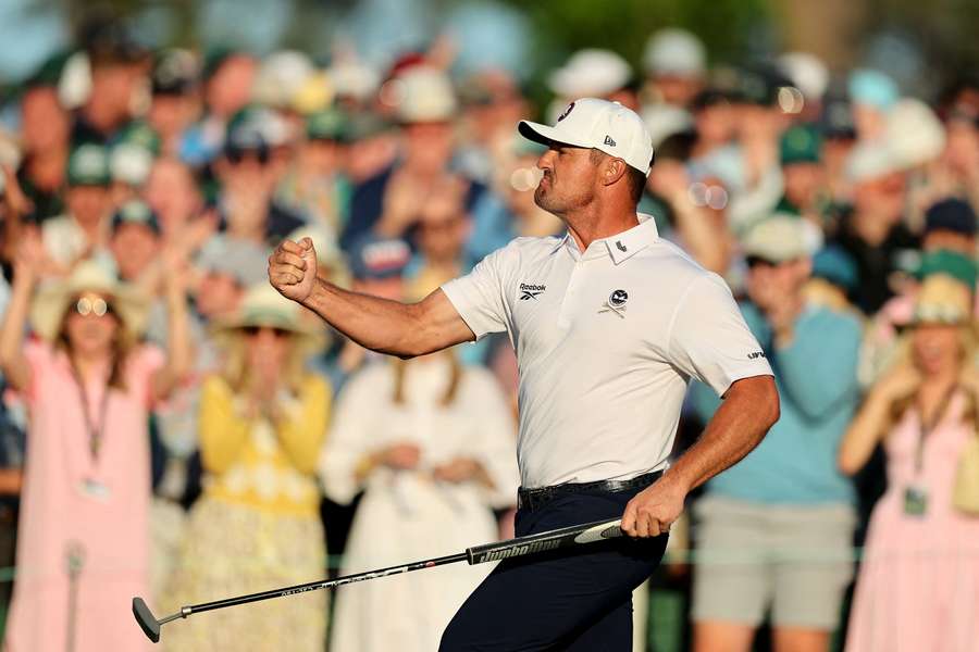 Bryson DeChambeau celebrates after sinking a putt on the 18th hole during round two of the 2025 Masters Tournament