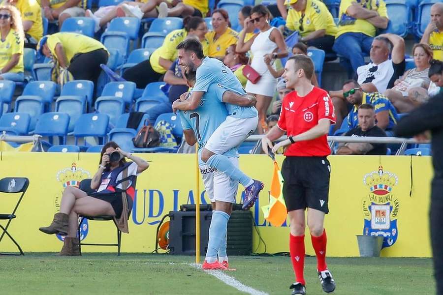 Arthur Melo of Girona runs with the ball under pressure from Pablo Duran of Celta Vigo