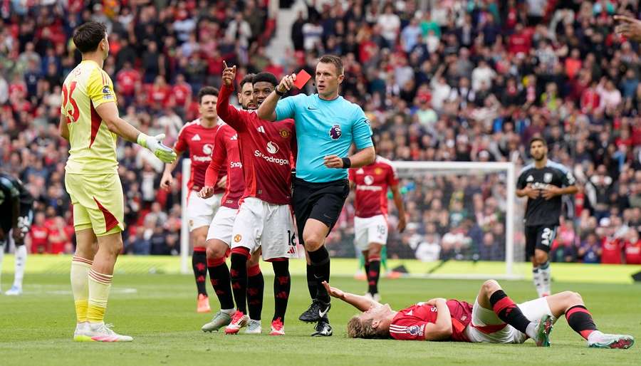 Referee Thomas Bramall shows a red card to Emiliano Martinez during Aston Villa's game against Manchester United Referee Thomas Bramall shows a red card to Emiliano Martinez during Aston Villa's game against Manchester United