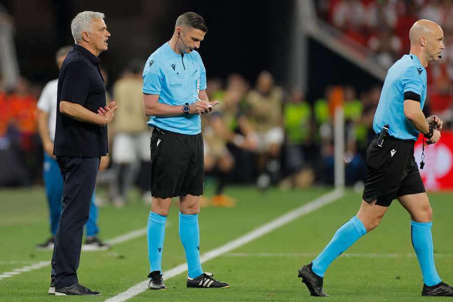 Mourinho cautioned by referee Taylor during the Europa League final