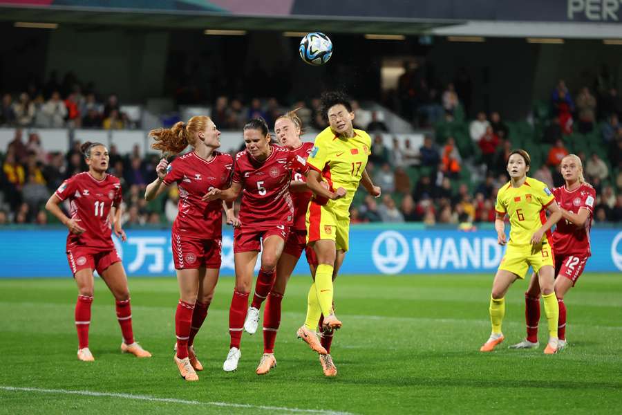 Danish and Chinese players jostle for a ball aerially