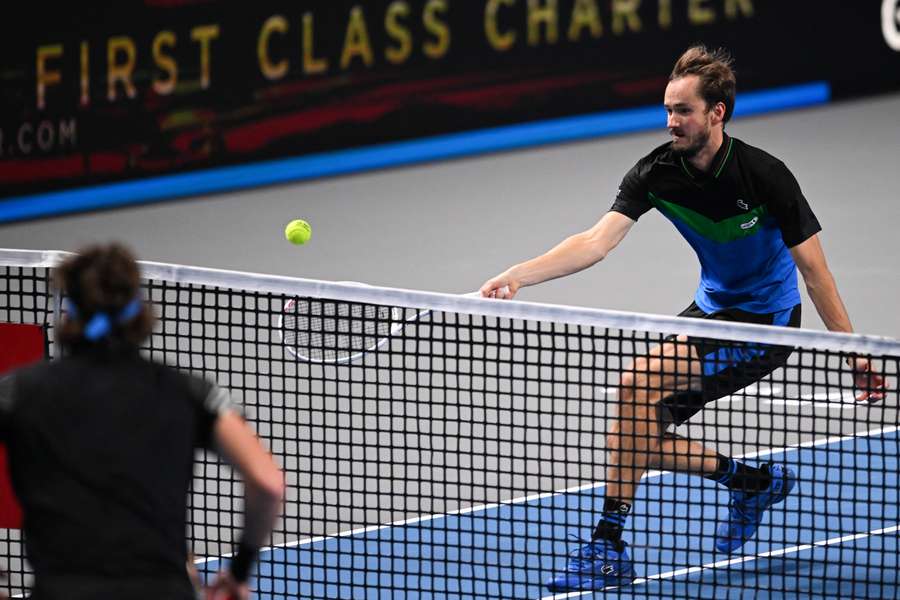 Daniil Medvedev plays a shot against Stefanos Tsitsipas in their semi-final clash