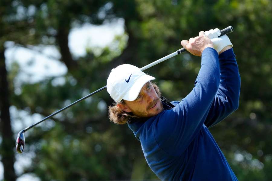 England's Tommy Fleetwood plays his tee shot on the 18th on the first day of the British Open Golf Championships