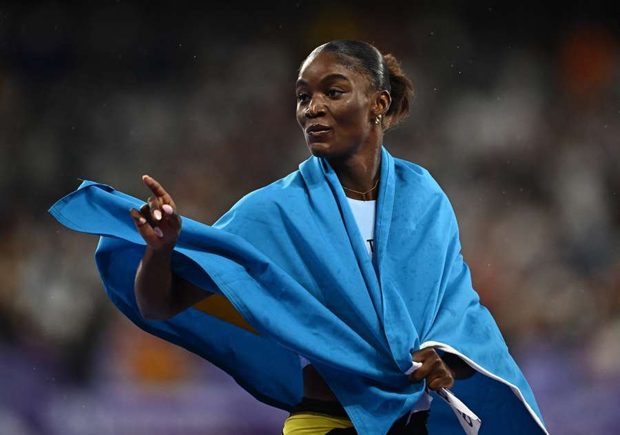 Alfred celebrates with the Saint Lucian flag after the race