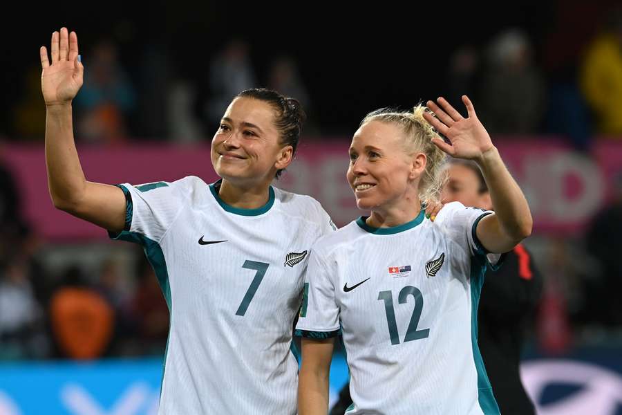 Riley (L) walks around the pitch with Betsy Hassett