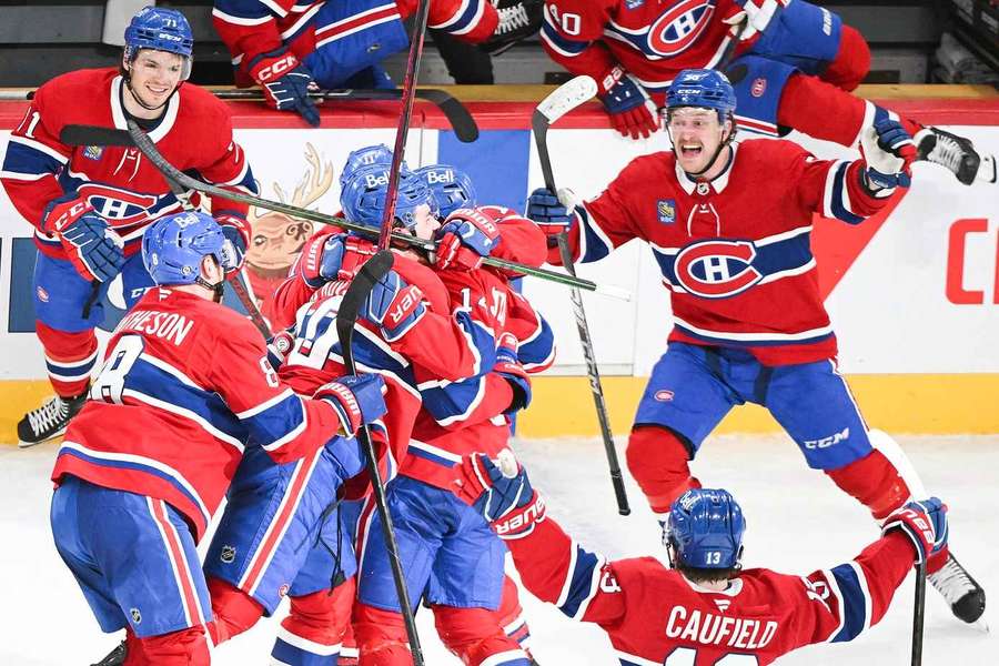 Montreal Canadiens' Nick Suzuki celebrates with teammates after scoring the winning goal during overtime against the Florida Panthers