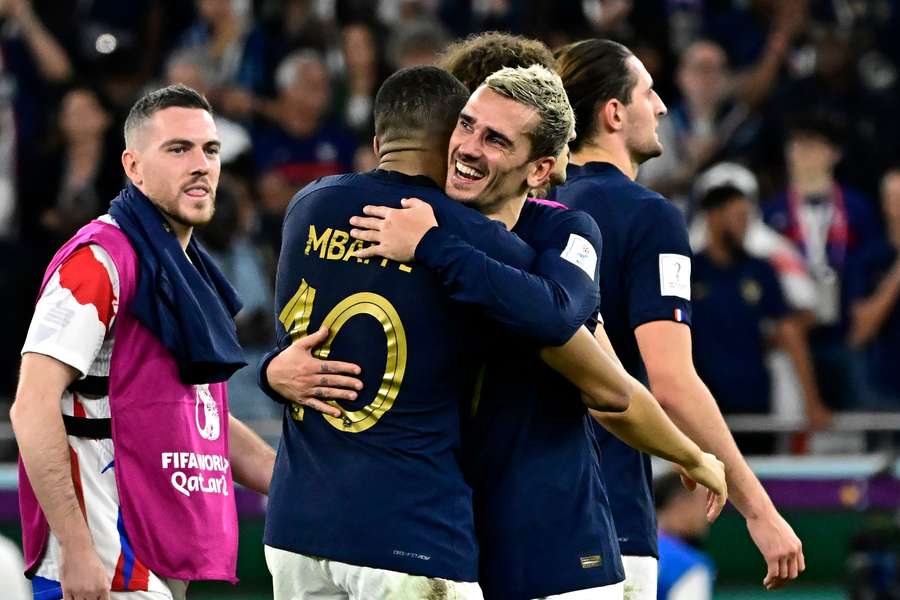 Antoine Griezmann se abraza con Kylian Mbappé