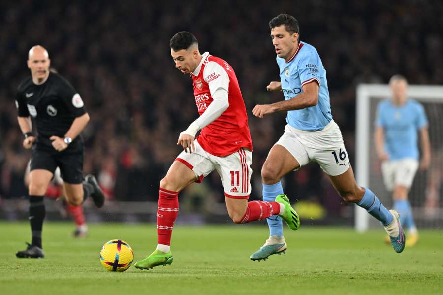 Gabriel Martinelli fights for the ball with Manchester City's Spanish midfielder Rodri 